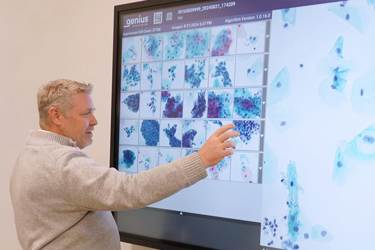 Man using a touch screen on medical device in an office setting.