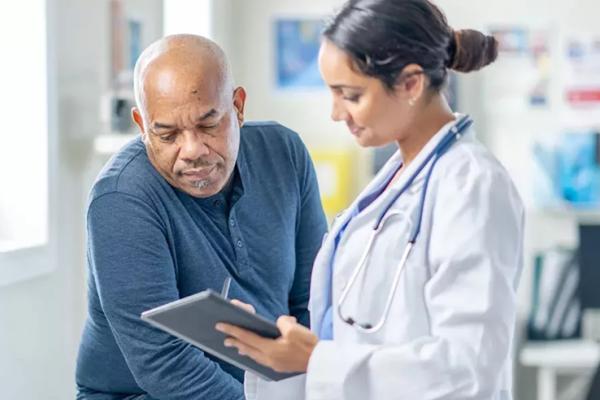 Doctor and Patient reviewing profiling test on a tablet