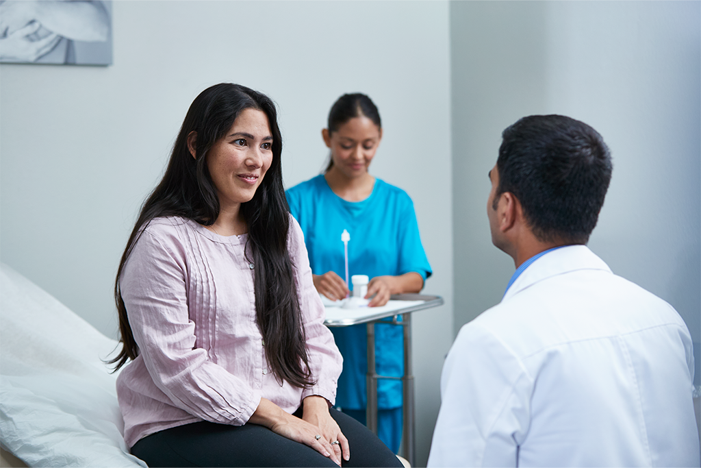 Patient speaking with physician in examination room