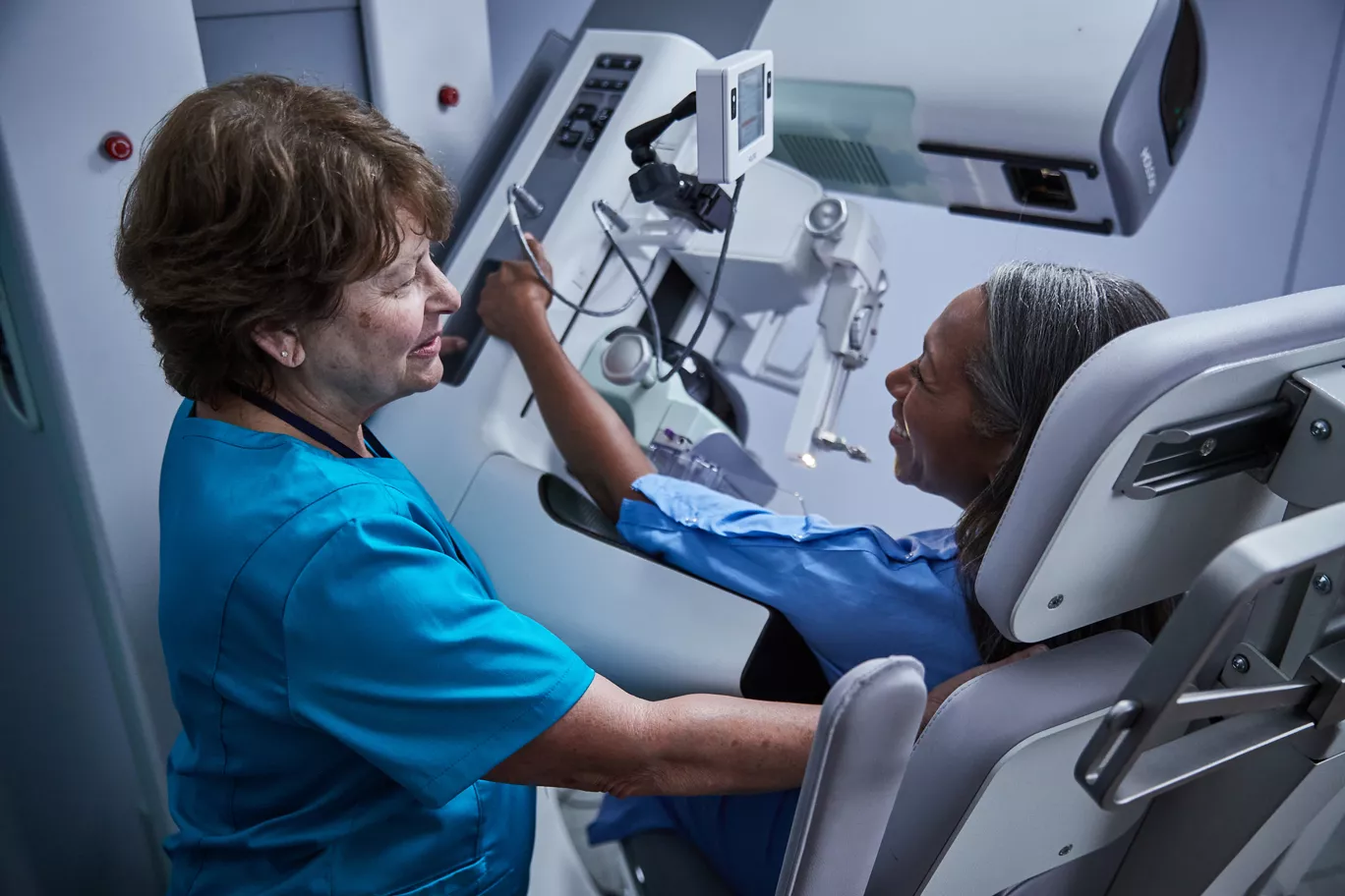 Provider talking to patient during exam in a lab setting.