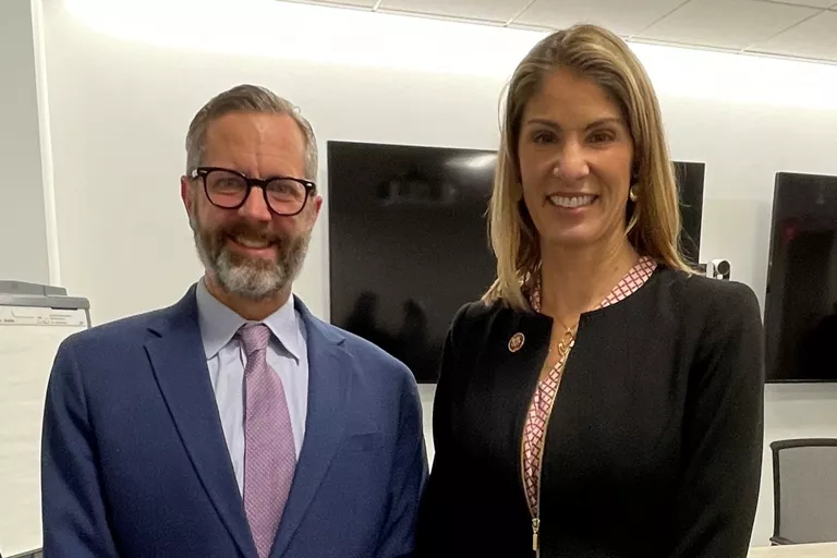 Lawmaker and leader smiling for photo in office setting