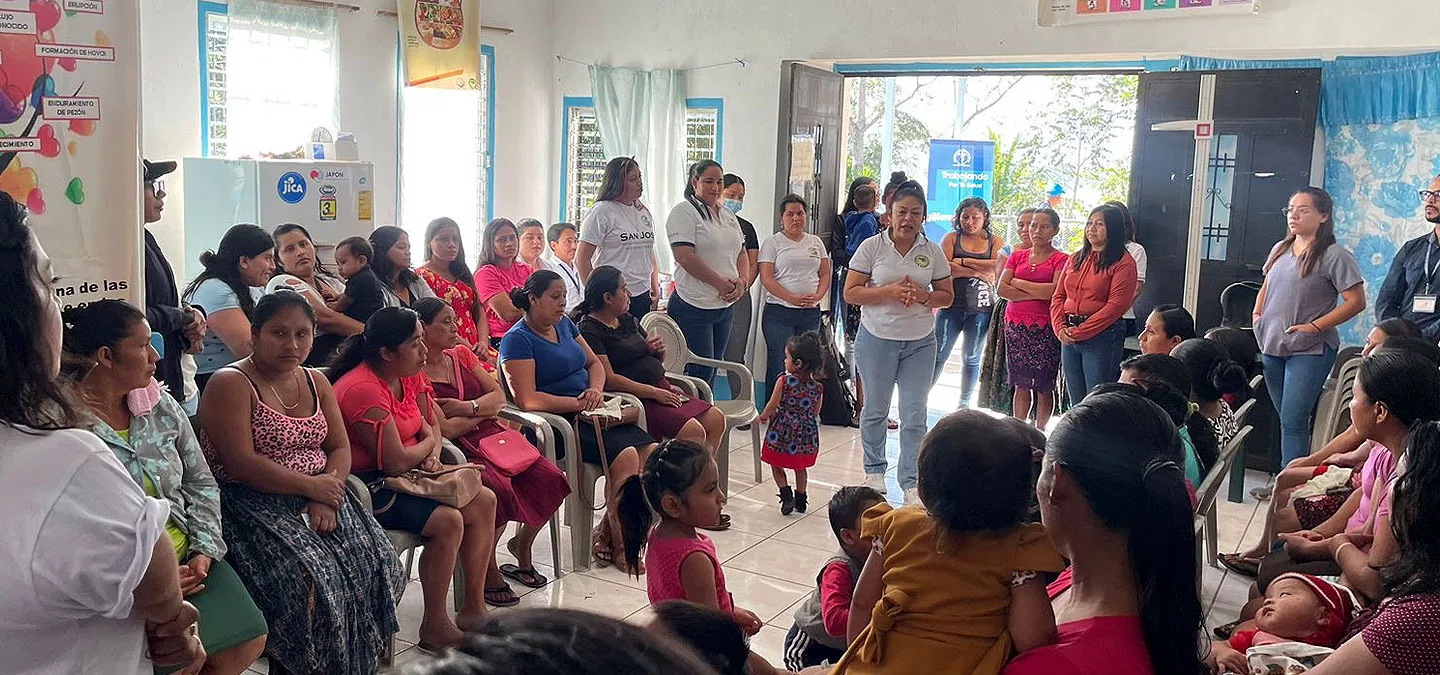 Interior group photo of children and adults