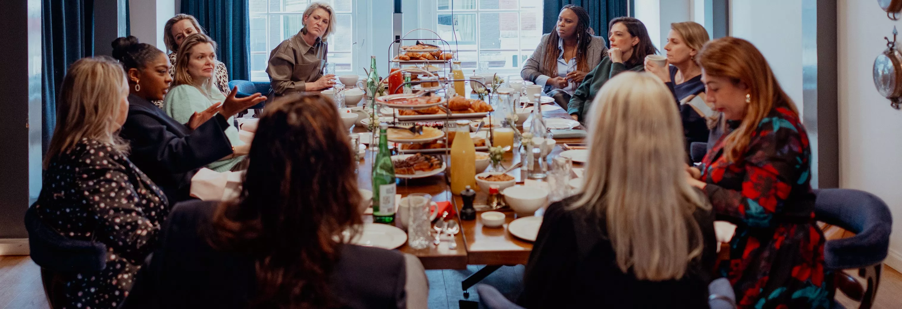 Group photo of women having dinner at table