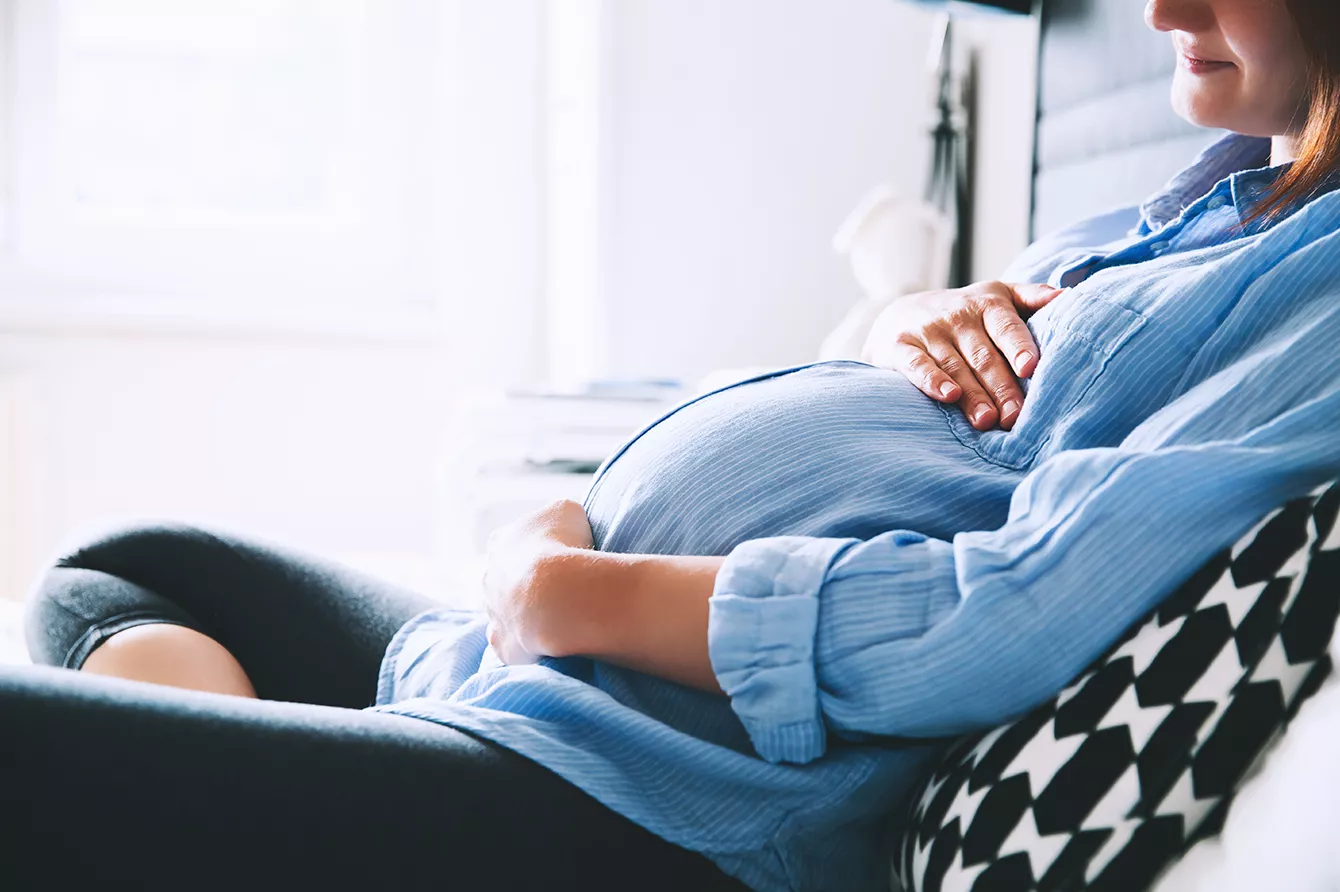 Pregnant woman in office setting.