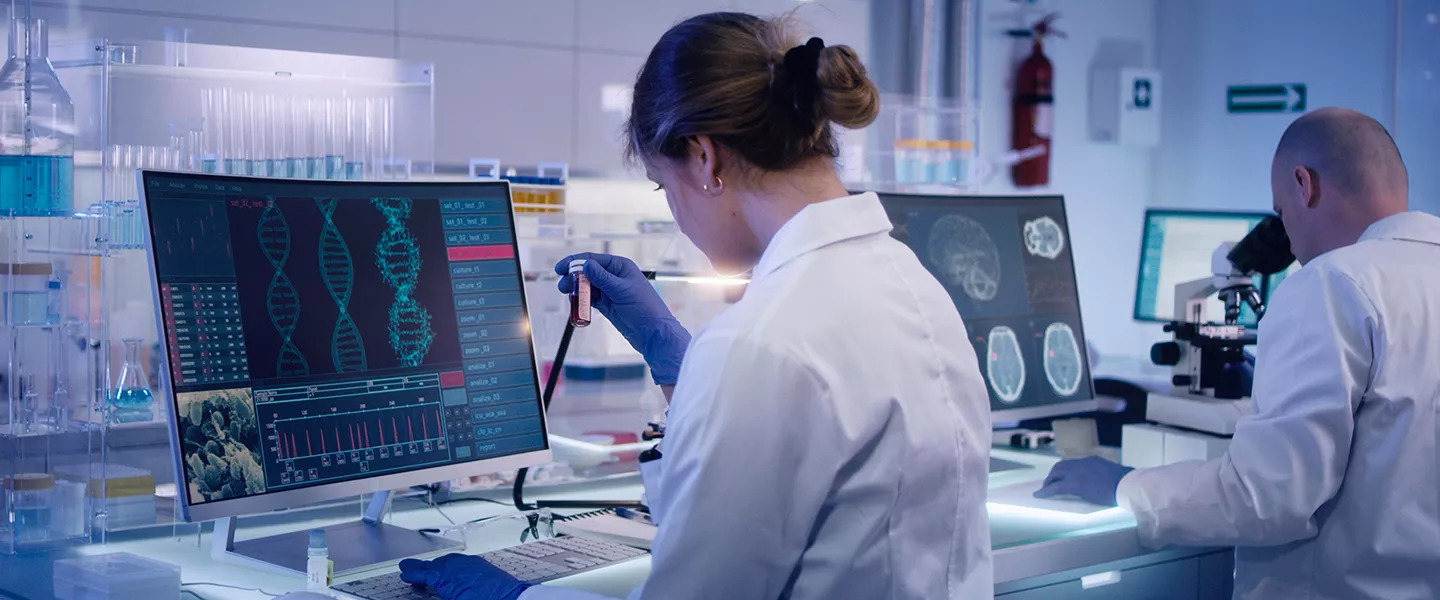 Technician looking at a monitor in lab setting