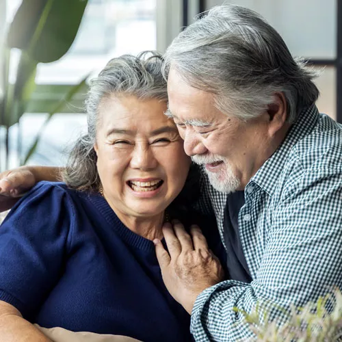 Photo of older couple laughing.